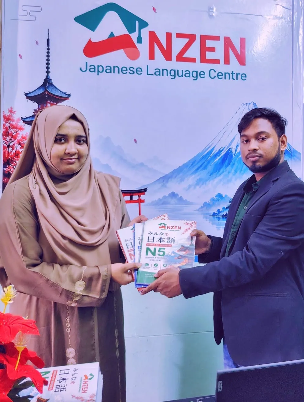 Teacher giving an N5 Japanese language book to a female student during a Japanese language learning session at Anzen Japanese Language Centre.